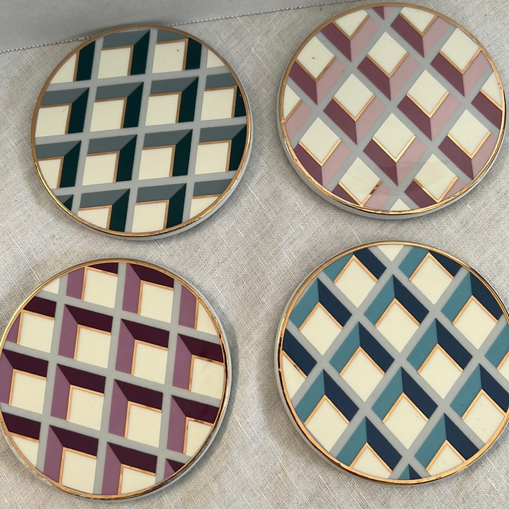 4 ceramic geometric 4” coasters. Blue, pink, gray and purple.